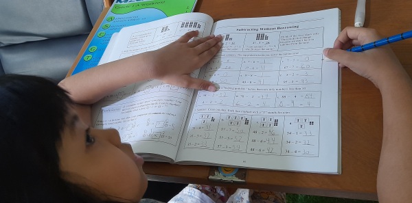 A 7-year old girl in Asia working on Math Mammoth first grade curriculum