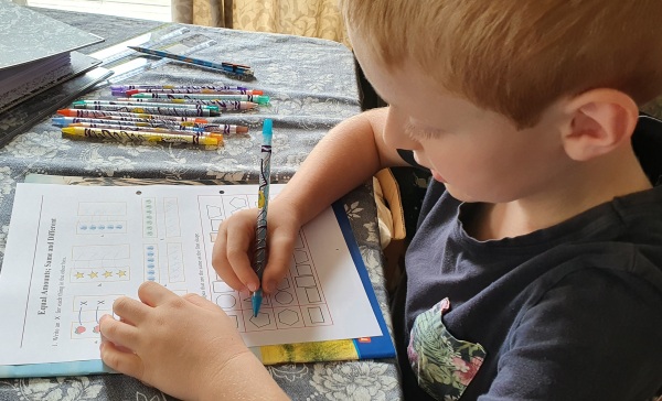 boy doing math worksheet