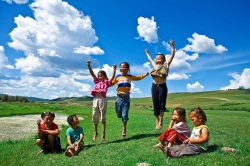 Happy children on a grassy hillside