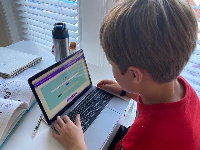 boy doing math practice problems online
